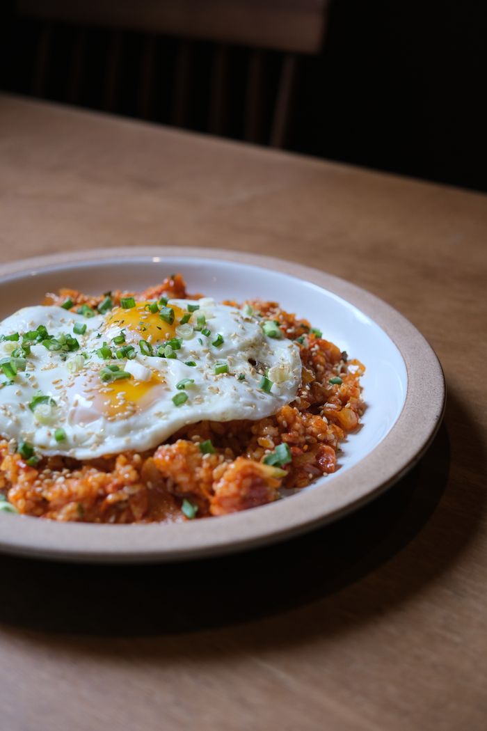 about-us-02 Savor a delicious plate of fried rice topped with a perfectly cooked egg, ideal for a satisfying breakfast.