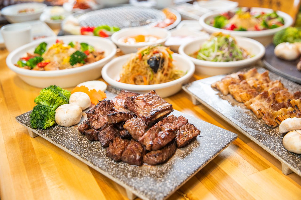 about-us-01 A tempting array of Asian dishes including grilled meat and vegetables served in a welcoming indoor setting.