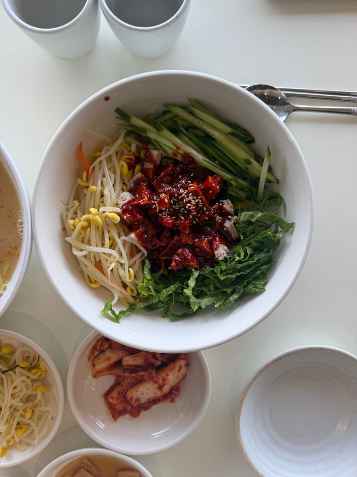 about-us-02 Delicious Korean bibimbap served with fresh vegetables and spicy sauce in South Korea.